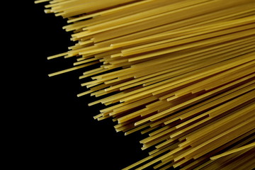 Spaghetti, yellow pasta isolated on black background, clipping path