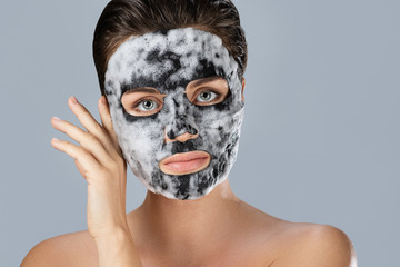 Woman with  bubble sheet mask on her face