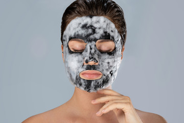 Woman with  bubble sheet mask on her face