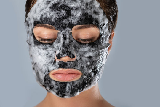 Woman With  Bubble Sheet Mask On Her Face