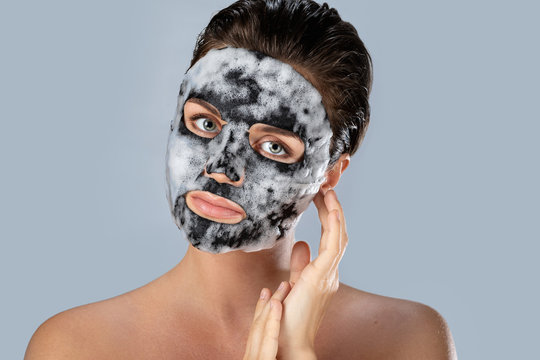 Woman with  bubble sheet mask on her face