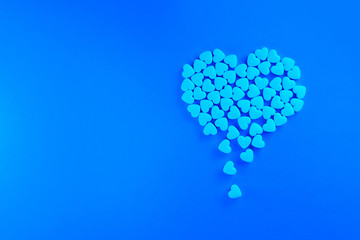 Concept illustration. Heart made of blue shugar candies.