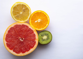 Fototapeta na wymiar Slices of grapefruit, orange, kiwi and lemon.