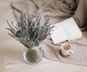lavender bouquet with book and cup of coffee on wooden background. Dried flowers and a cup of cappuccino  with book, spring concept. top view. flatlay