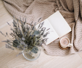 cup of cappuccino coffee with book on wooden background with copy space, dried flower background, lovely breakfast 
