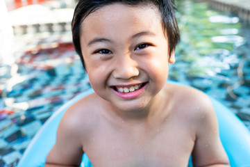 Little boy in the swimming pool. Summer holiday concept