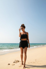 Stylish and beautiful woman on the beach