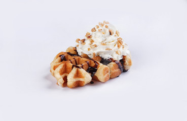 waffle with whipped cream chocolate and peanuts on a white background