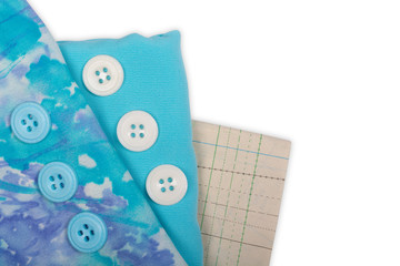 Sewing. Turquoise and abstract fabric with a pattern, pattern for sewing clothes and white buttons. Isolate on white background, Flat Lay, Copy space,