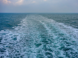Wind and waves, dark clouds, and boat sights on the sea captured on a cruise ship
