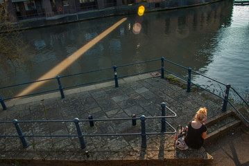 Women sit and relax beside the Avon River.