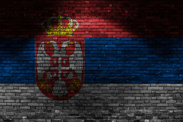 Serbia flag on brick wall at night