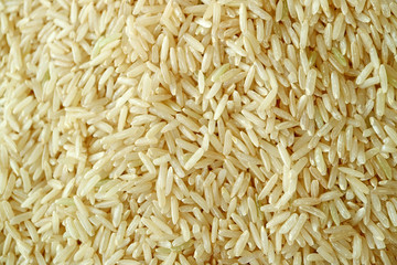 Heap of Raw Thai Brown Jasmine Rice or Hom Mali Rice for Texture, Background, Banner