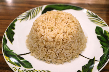 Closed Up a Plate of Steamed Thai Brown Rice Served on Wooden Table