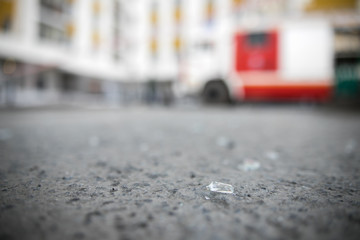 Shards of broken car glass on the asphalt road