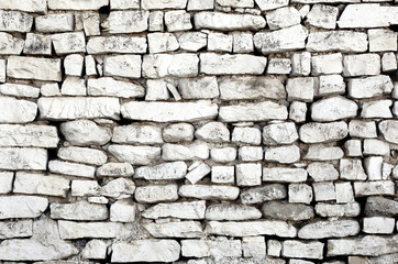 Rustic old wall with white bricks, different sizes