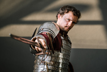 Medieval knight pointing sword to camera