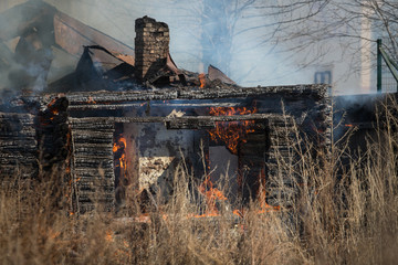 Completely burnt wooden house. Consequences of fire