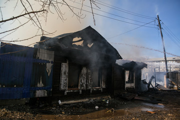 Completely burnt wooden house. Consequences of fire