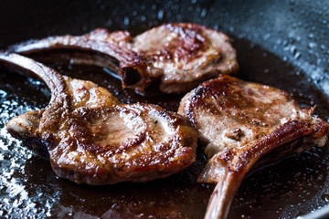 Fototapeta premium Fried Lamb Chops in Pan. Grilled and Sauteed
