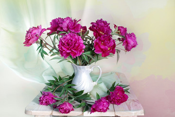 Still life with beautiful peonies in a vase on the table
