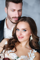 Portrait of beautiful wedding couple together. Bride and groom kiss and hug each other
