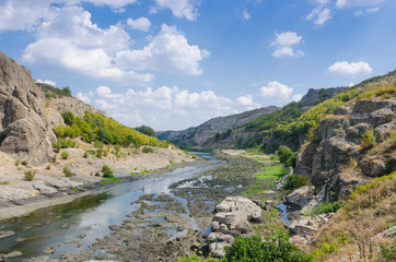 Fototapeta na wymiar Abrasive basalt rocks at the bottom of the Arda River behind the Studen Kladenets dam, Bulgaria