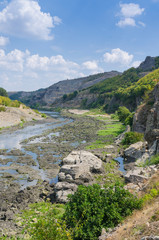 Fototapeta na wymiar Abrasive basalt rocks at the bottom of the Arda River behind the Studen Kladenets dam, Bulgaria