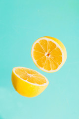 Lemon slices on a blue background. Lemon cut outs on a turquoise  background.