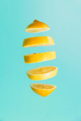 Lemon slices on a blue background. Lemon cut outs on a turquoise  background.