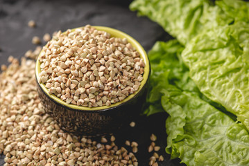 Croup green buckwheat on a dark background. Vegan nutritious and healthy product. Concept of organic food