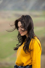 Beauty fashion portrait of young beautiful brunette girl with long black hair and green eyes. Beauty portrait of female face with natural skin.