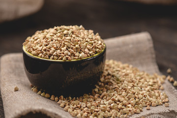 Green buckwheat on a dark background. Vegan nutritious and healthy product. Concept of organic food