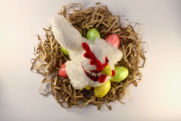 Chicken in a wavy nest with colorful Easter eggs. Chicken in a wavy nest with colorful Easter eggs....