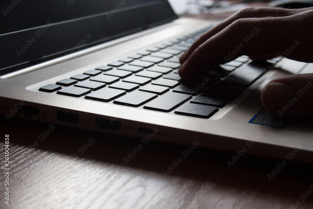 Poster photo of a laptop keyboard with selective focus on the keys and a soft and warm bokeh background