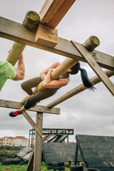 Female participant in a obstacle course doing weaver obstacle