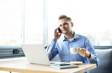 Stylish young man calling by the phone to solve business problems. Online consultation by phone....