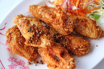 Plate of Northern Thai Deep Fried Chicken Wing with Hot and Spicy Herbs