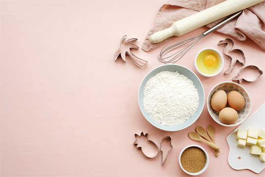 Baking ingredients and utensils on pink background. Cooking or baking cake, cookies, pastry concept. Top view, copy space