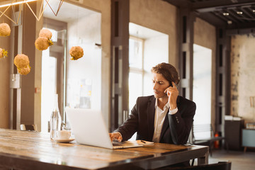 Young handsome businessman conducting negotiations with investors. Electronic business. Alternative...