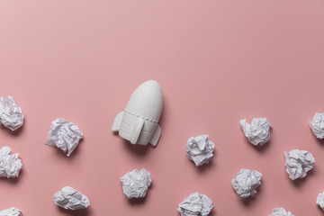 Business startup concept. Rocket taking off with crumpled paper trail
