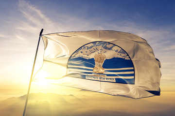 Himachal Pradesh state of India flag waving on the top sunrise mist fog