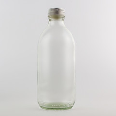 Empty glass bottle, isolated, white background