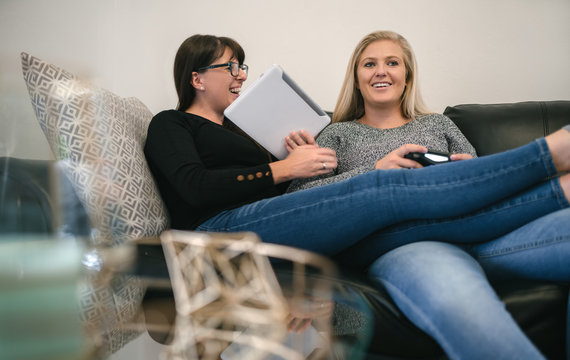Young lesbian couple relaxing at home - Powered by Adobe