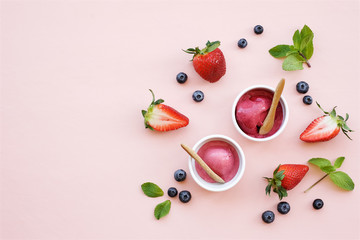 Berry sorbet on a light pink background. Ice cream in bowls. Copy space, top view