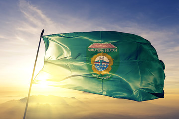 South Sumatra province of Indonesia flag waving on the top sunrise mist fog