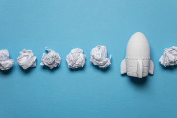 Business startup concept. Rocket taking off with crumpled paper trail