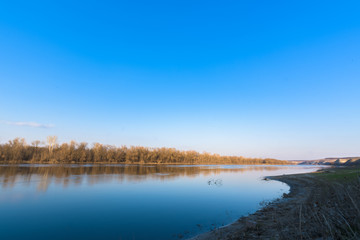 panorama of the river. wide channel, blue sky. mountain shore