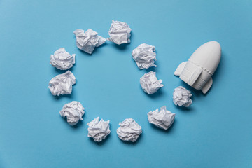 Business startup concept. Rocket taking off with crumpled paper trail