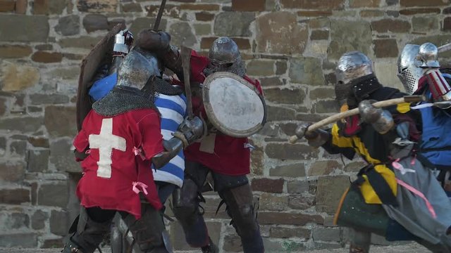 Fierce battle of knights against the castle walls Strikes with swords shields and axes
